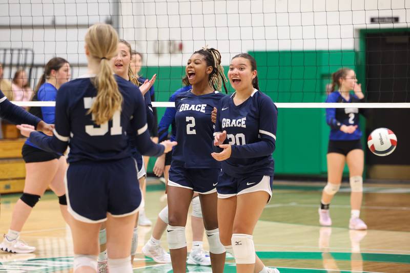 Grace Christian's Arianna Trivino, right, and Zoey Baldridge celebrate a point with teammates during the Crusaders' victory in two sets, 25-20, 25-16, over Clifton Central in the IHSA Class 1A Dwight Regional quarterfinals on Monday, Oct. 27, 2025.