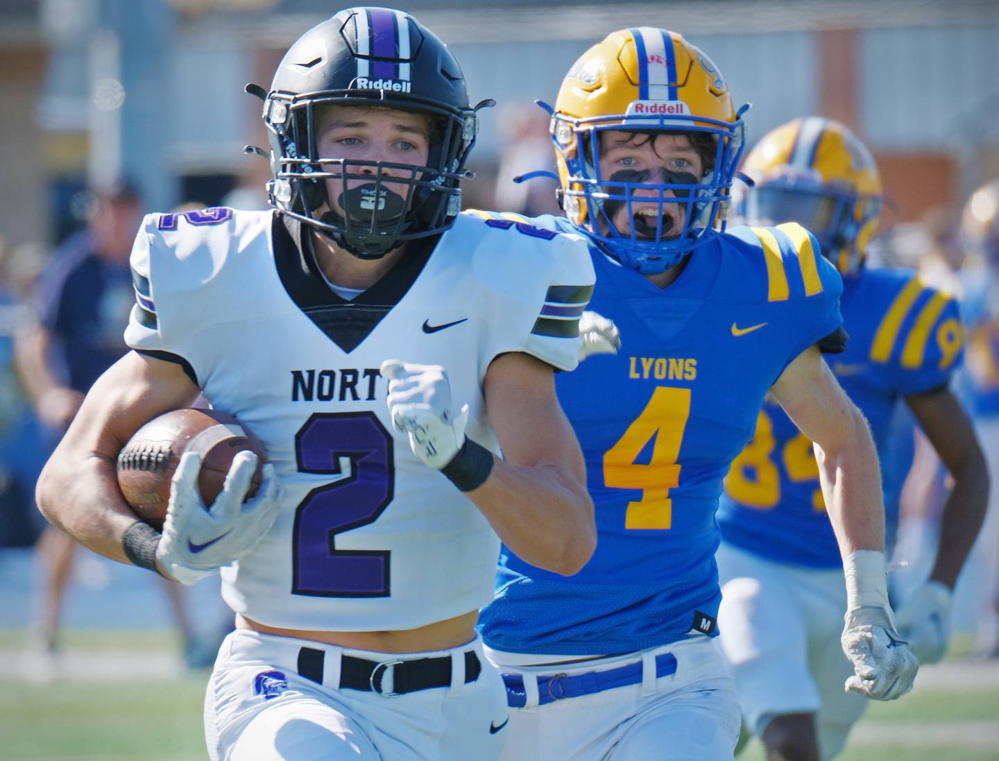 Downers Grove North wide receiver Will Guerin (2) races to the end zone after making a catch in front of Lyons Township's Quinn Farnan during a game on Oct. 22, 2022 at Lyons Township High School in LaGrange.