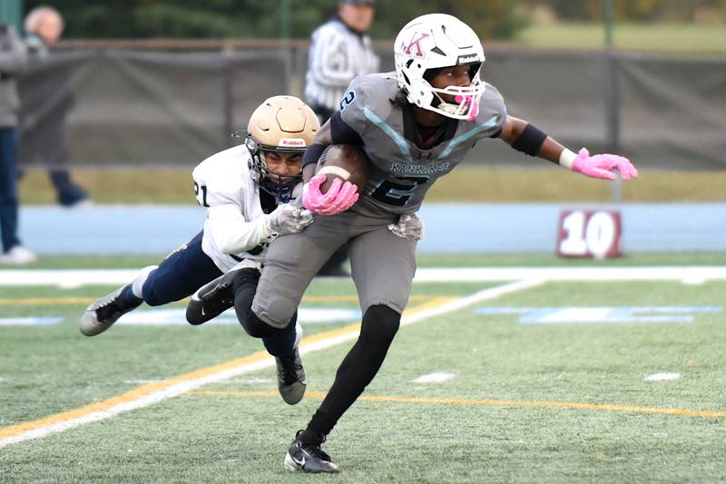 Kankakee's Ezekiel Sherrod (2) breaks a tackle attempt from Lemont's Ewald Trickle during an IHSA Class 5A first round playoff game at Kankakee Saturday, Nov. 1, 2025.