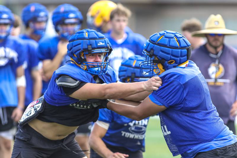 Roman Sossnovyy (L) engages a blocker at Lyons football practice, Monday, Aug 18, 2025  in Western Springs.