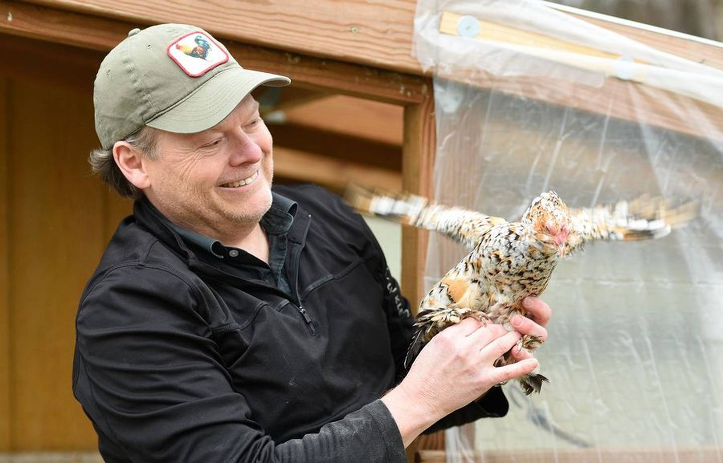 Andy Atwell holds a bantam chicken from his backyard flock.