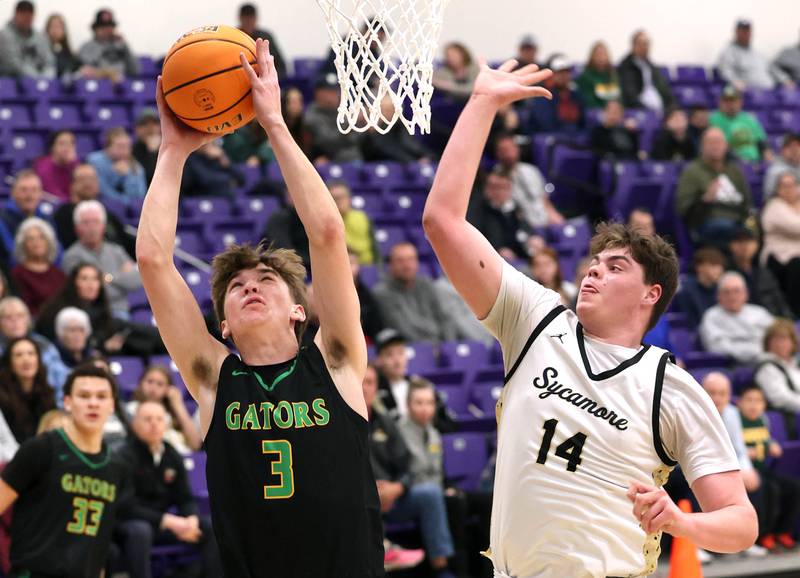 Crystal Lake South's Nick Stowasser scores and is fouled by Sycamore's Michael Chami during their sectional semifinal game Tuesday, March 4, 2025, at Rochelle High School.