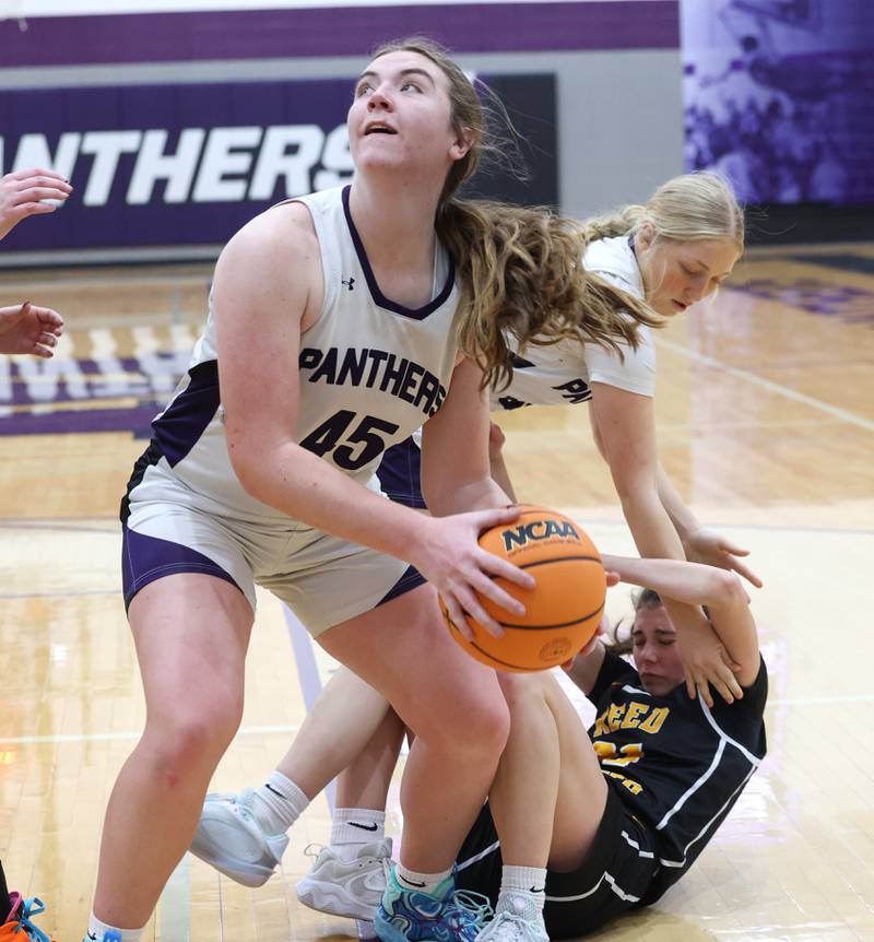Manteno's Emily Horath comes away with a rebound and looks to shoot as Reed-Custer's Alyssa Wollenzien falls away during Reed-Custer's 45-42 victory over Manteno on Monday, Feb. 2, 2026.