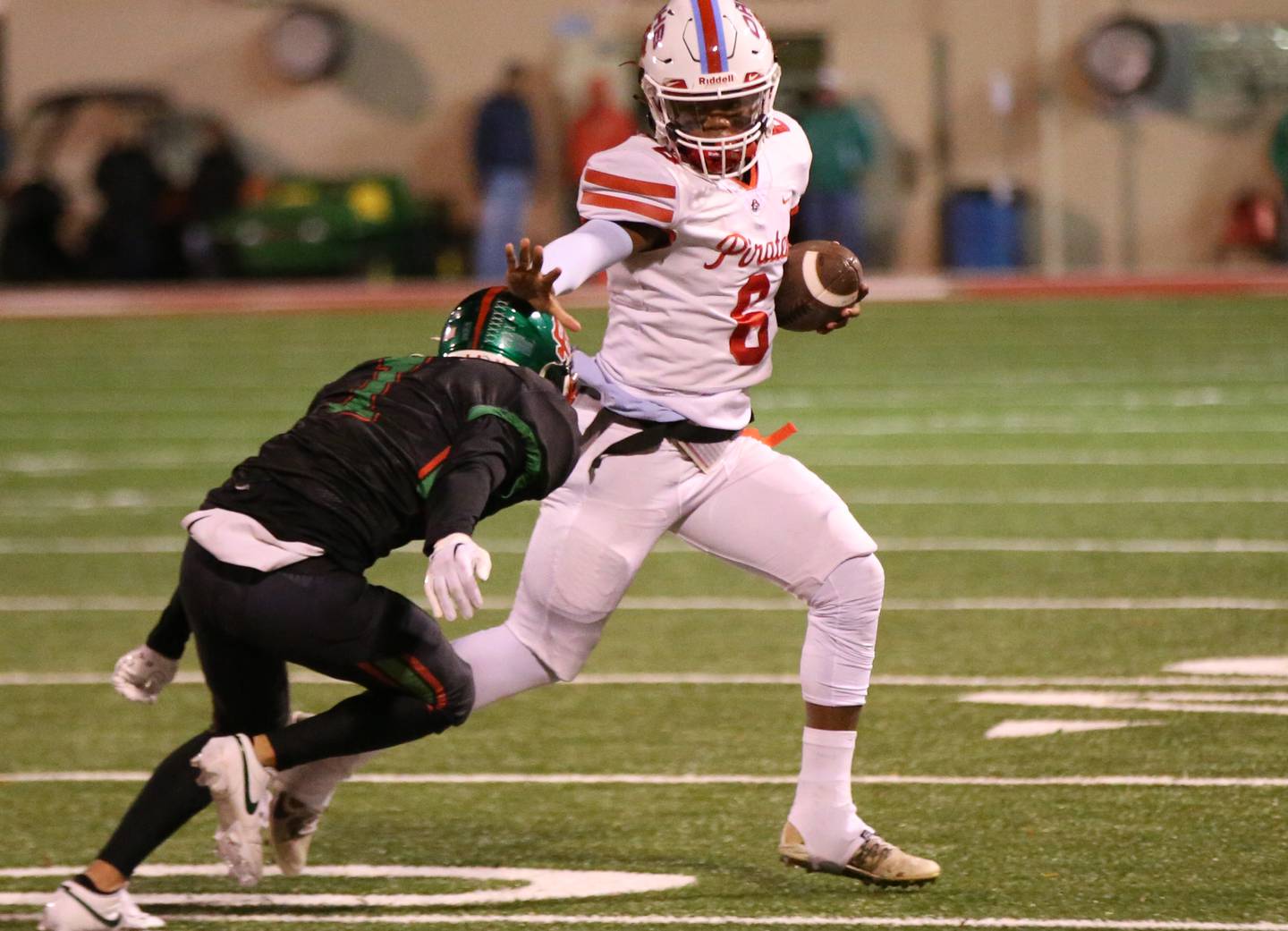 Ottawa quarterback Colby Mortenson stiff arms L-P's Noah Zebron on a run on Friday, Oct. 6, 2023 at Howard Fellows Stadium.