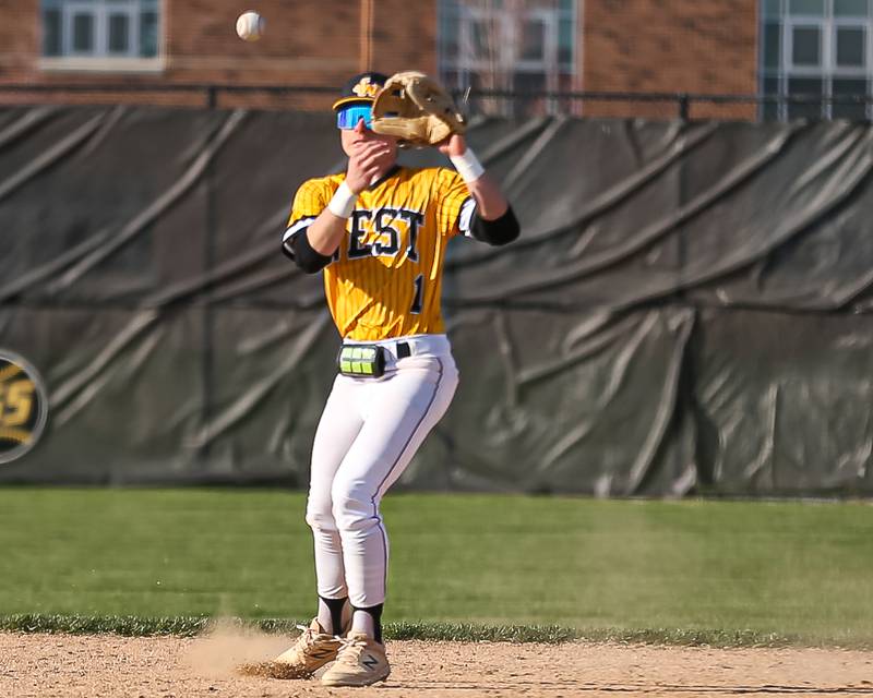 Joliet West's Cael Karczewski (1) fields a bouncer to second during varsity baseball game between Oswego East at Joliet West.  April 10, 2023.