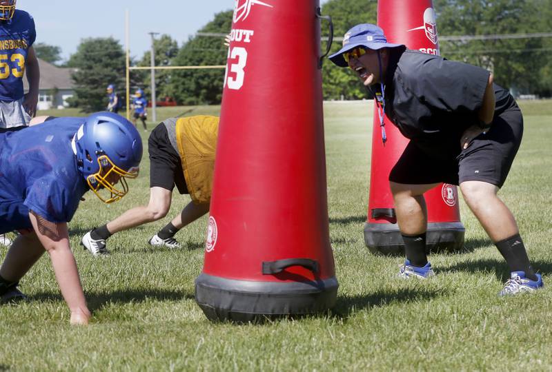 Johnsburg Assistant Coach Mark Landvick encourages players as they run tackling drills during summer football practice Thursday, June 23, 2022, at Johnsburg High School in Johnsburg.