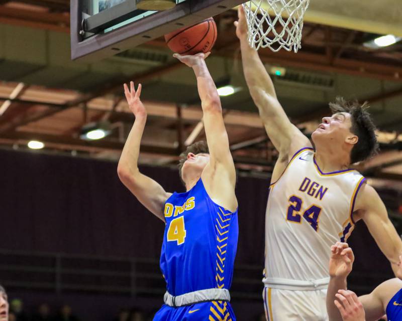 Downers Grove North's George Wolkow (24) blocks a layup attempt by Lyon's Connor Carroll (14) during varsity basketball game between Lyons at Downers Grove North.  Jan 31, 2023.