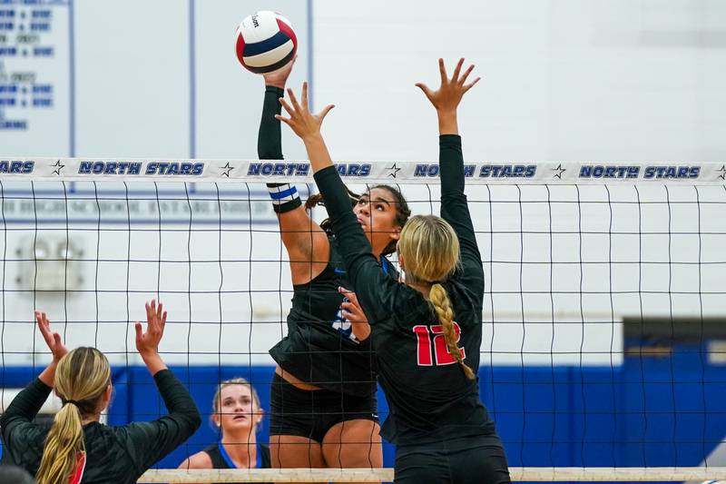 St. Charles North's Sidney Wright (22) goes up for a kill against Huntley’s Summer Massow (12) during a non-conference match at St. Charles North High School on Wednesday, Sept. 3, 2025.
