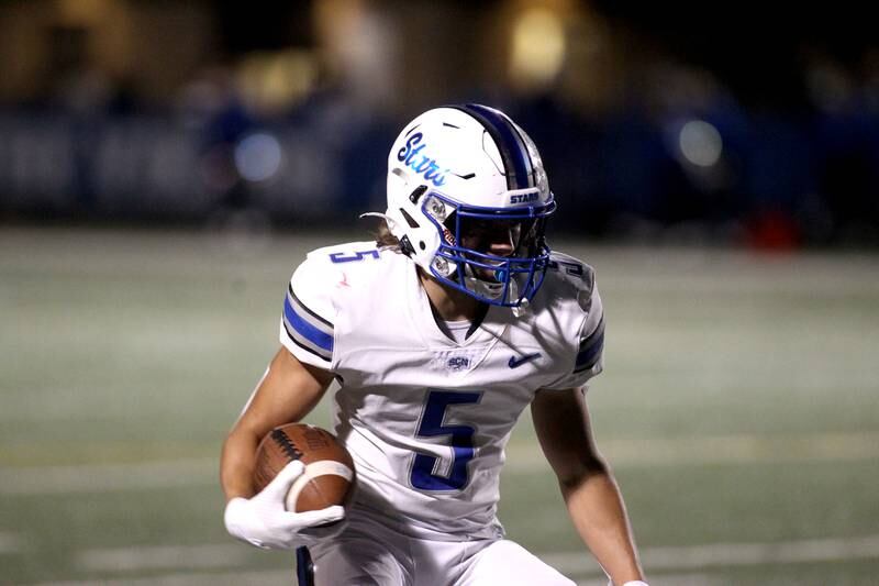 St. Charles North’s Anthony Taormina carries the ball during a game at Geneva on Friday, Sept. 23, 2022.