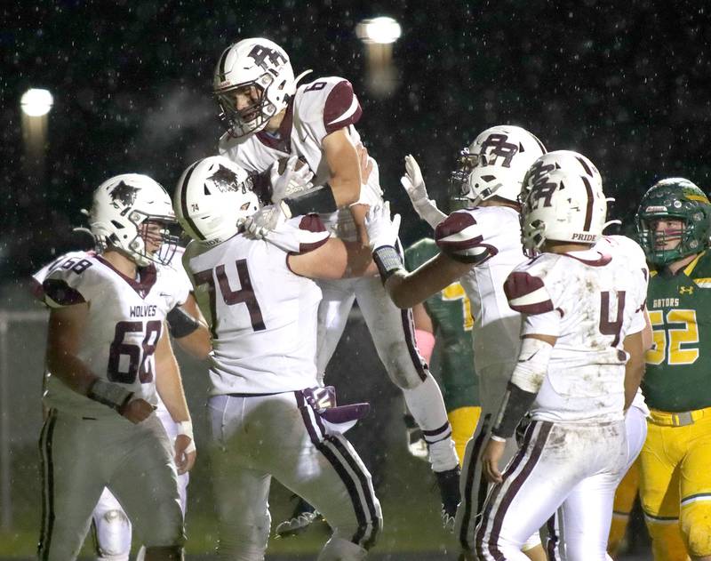 Prairie Ridge’s Luke Vanderwiel gets a lift from teammates after scoring in varsity football action at Ken Bruhn Field on the campus of Crystal Lake South Friday evening.