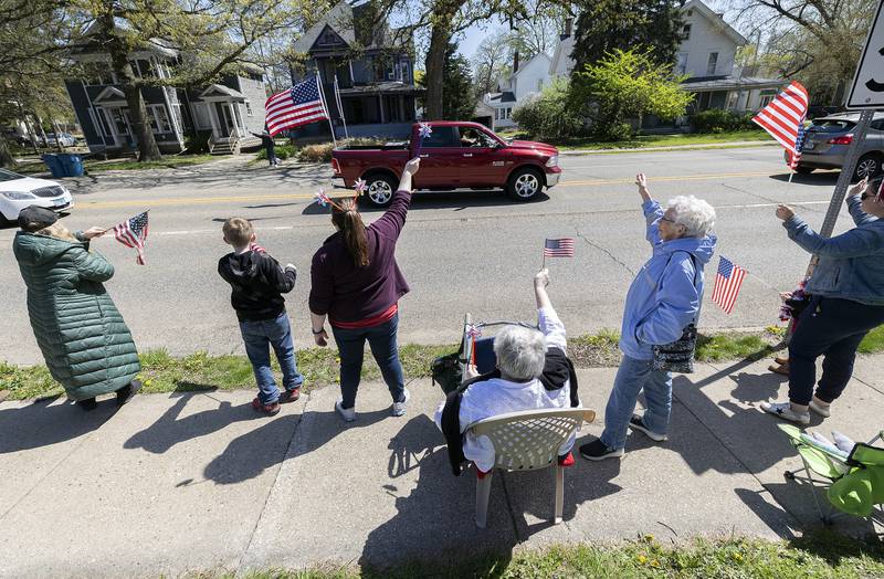 Well wishers wave flags to celebrate passing veterans Saturday, April, 26, 2025. Dixon VFW Post 540 held a Vietnam veteran parade down Galena Avenue to recognize those veterans who didn’t receive the thank you they deserved.