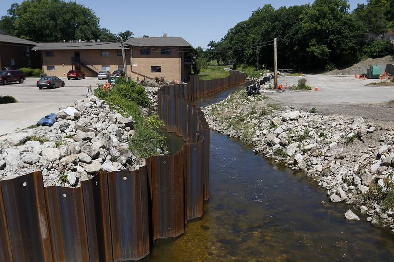 A cofferdam covers one side of Crystal Creek in Algonquin on Monday, June 20, 2022. The riverwalk and streetscape project is an extensive restructuring of the pedestrian pathways and Crystal Creek creek bed between Towne Park and the Fox River.