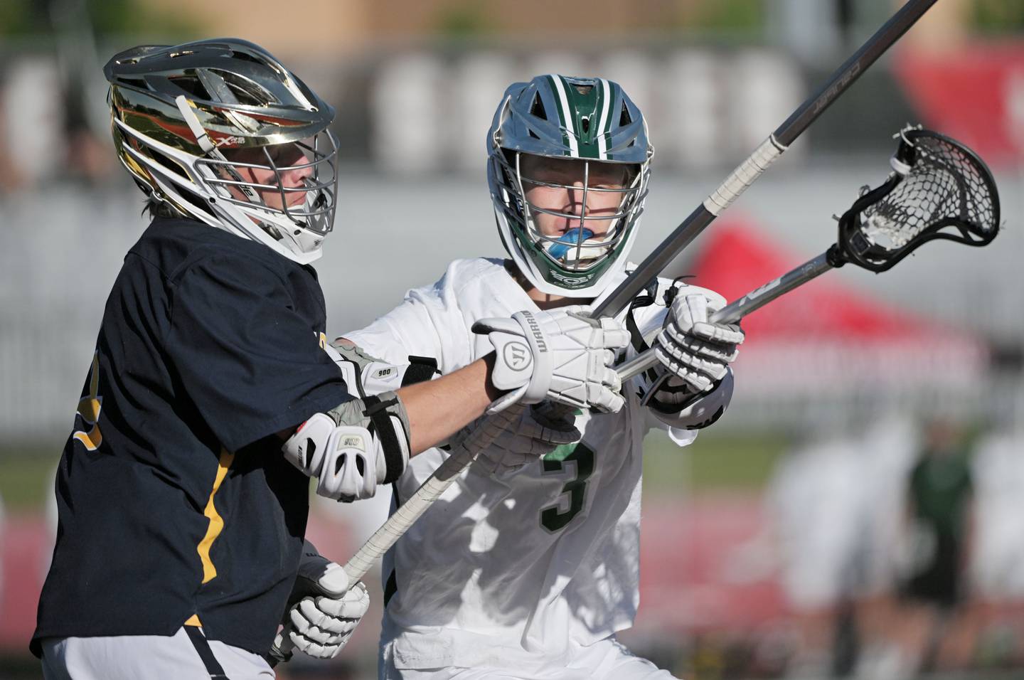 Glenbard West’s Sam Clark defends against Neuqua Valley’s Owen Matthews in the boys lacrosse state semifinal game in Hinsdale on Thursday, May 30, 2024.
