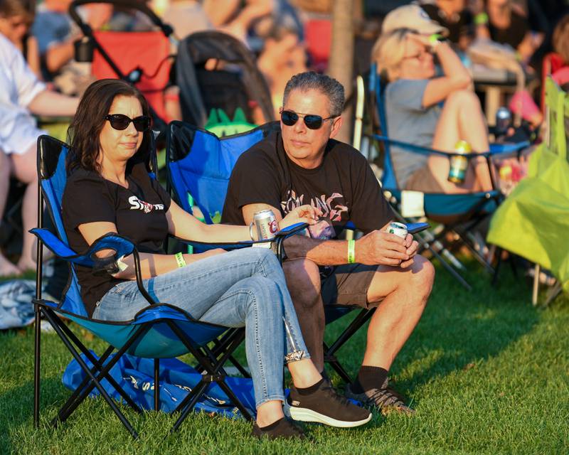 Denise LaForte and Frank Leo of Carol Stream relax and listen to Second Hand News, a Chicago- based Fleetwood Mac tribute band on Friday Aug. 2, 2024, before Rocks Off: A Tribute to The Rolling Stones preform at Memorial Park in Wheaton.