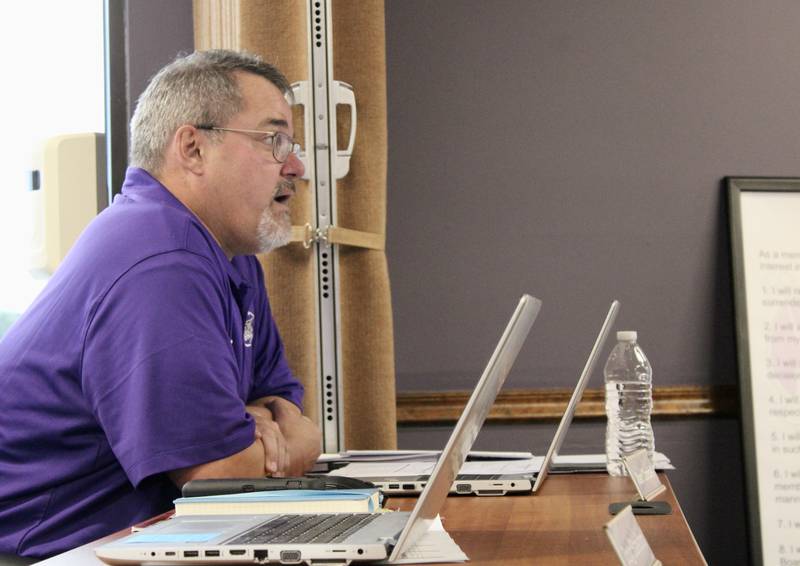 Marc Campbell, business manager for Dixon Public Schools, briefs the board of education on expected revenues during a budget hearing on Wednesday.