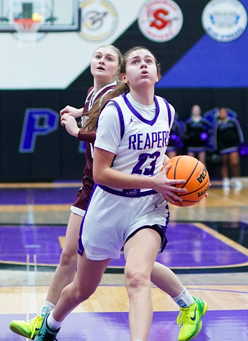 Plano's Josie Larson (23) drives to the basket against Marengo’s Macy Noe (30) during a basketball game at Plano High School on Wednesday, January 29, 2025.