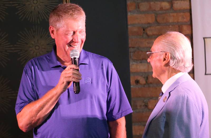 Marty Brown, member of the 1973-74 Marquette Boys Basketball Team, talks with emcee Lanny Slevin during the 2025 Shaw Media Illinois Valley Sports Hall of Fame at the Auditorium Ballroom in La Salle. The Marquette boys basketball team placed second in Class 1A.