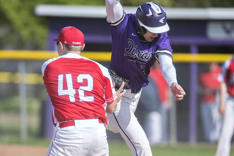 Dixon's Mason Randick is tagged out by Oregon's Kyle Strite running to third on a fielders choice.