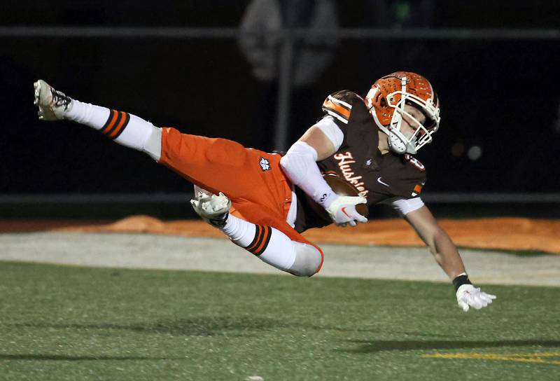 Hersey's Carson Grove (8) falls into the end zone after a long touchdown pass during the IHSA Class 7A playoffs Saturday October 28, 2023 in Arlington Heights.