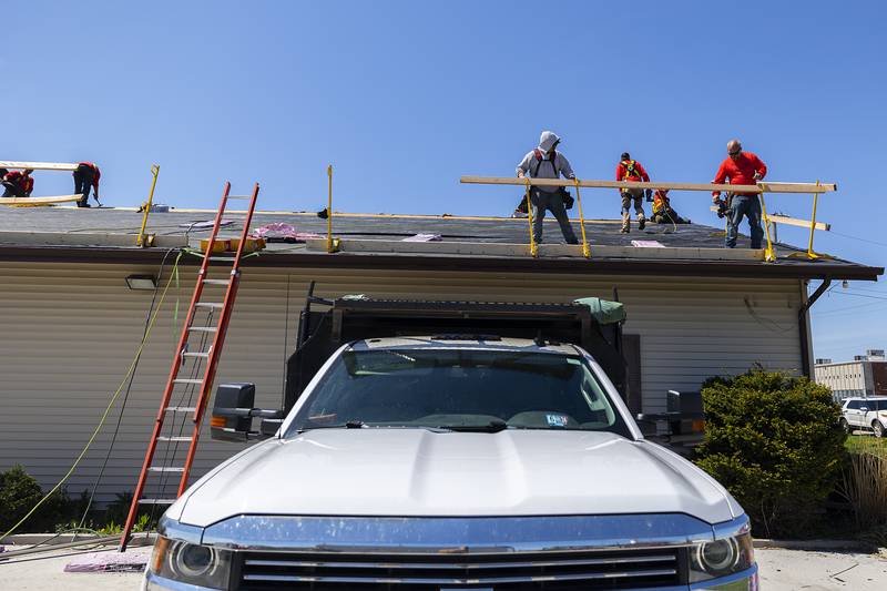 TCS, Total Construction Services of Sterling, work on the roof of the Twin Cities Homeless Shelter on Friday, April 19, 2024 in Sterling.