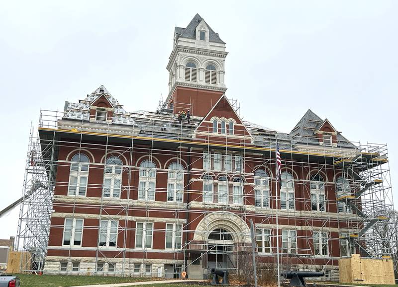 Scaffolding surrounds the historic Ogle County Courthouse in Oregon as  Sterling Commercial Roofing  workers remove slate shingles from the 134-year-old structure on Wednesday, Nov. 19, 2025.