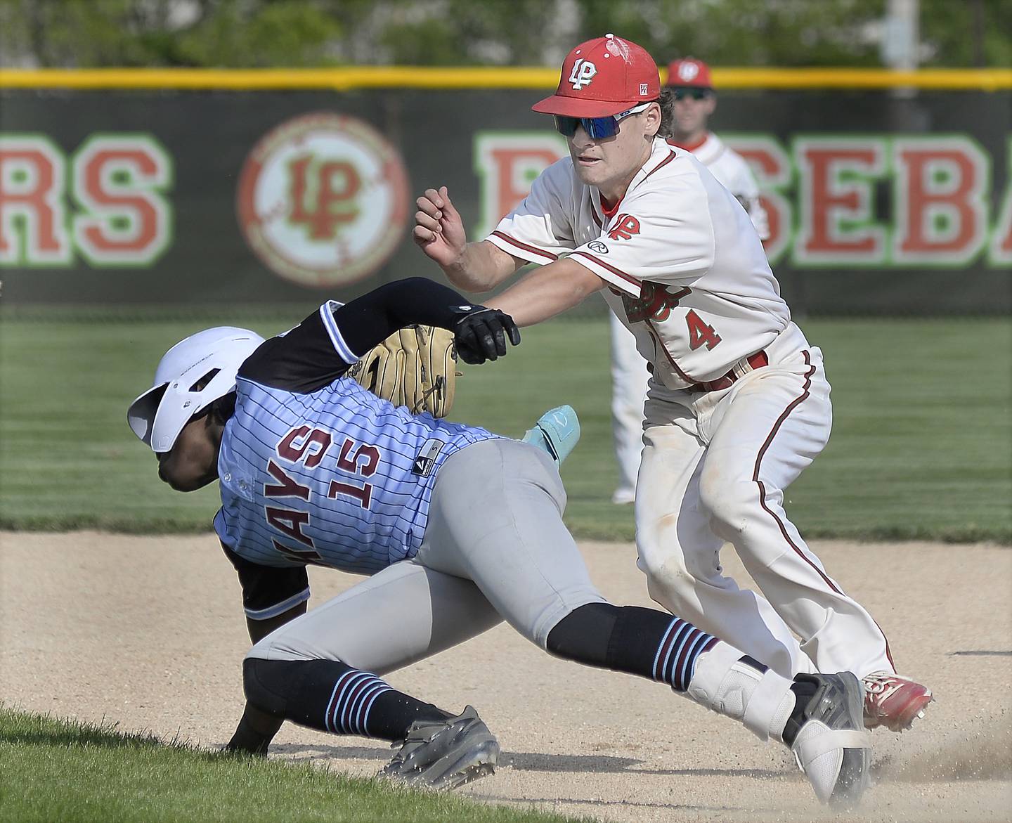 La Salle-Peru’s Jack Jereb tags out Kankakee’s Byron Wills, who was caught in a rundown, on Monday, May 22, 2023 in Oglesby.