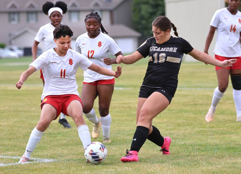 Sycamore's Charlotte Yates and Rock Island's Kampbell Allen try to gain possession Friday, May 22, 2026, during their Class 2A regional championship matchup at Sycamore High School.