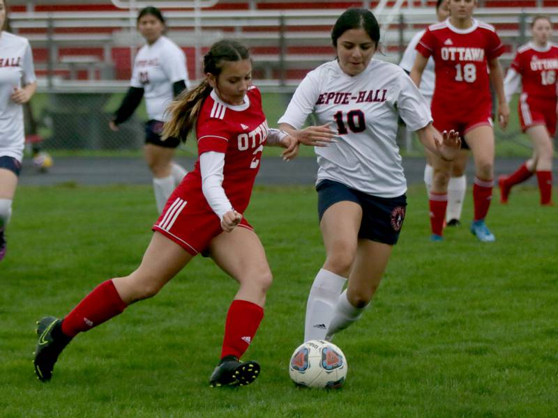 Ottawa's Yesenia Leon (2) kicks the ball upfield as DePue/Hall's Arianna Garcia (10) defends on Thursday, May 5, 2022, at King Field in Ottawa.
