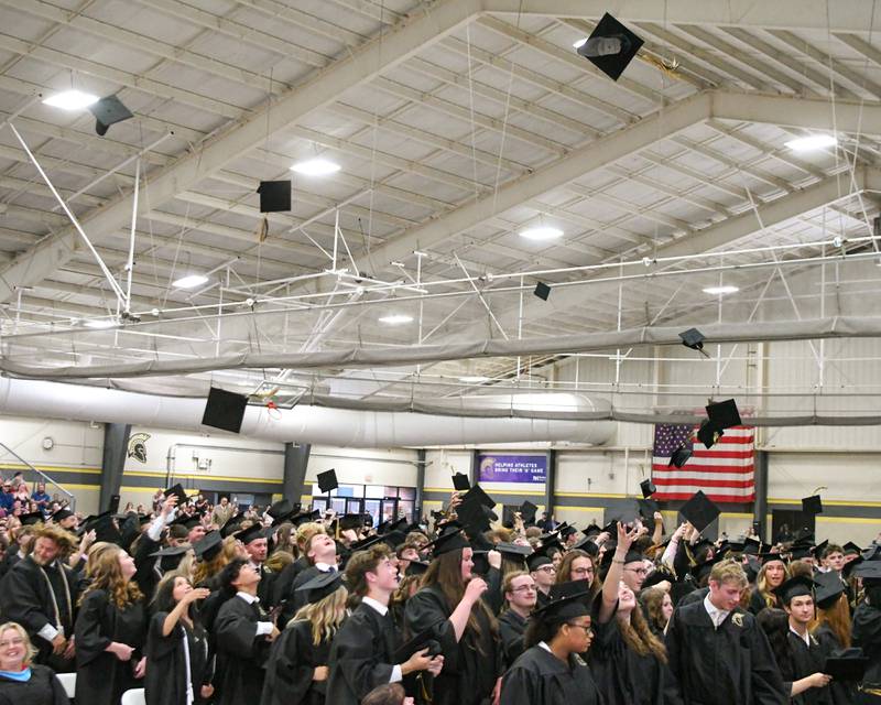 Sycamore High School seniors throw their caps in the air to celebrate on Sunday, May 25, 2025, at the end of the Class of 2025 Commencement ceremony at the high school.