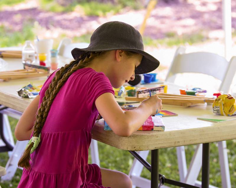 Clara McKee-Horsey, 9, paints during DeKalb's annual Juneteenth Community Celebration on Sunday, June 22, 2025, held at Hopkins Park.