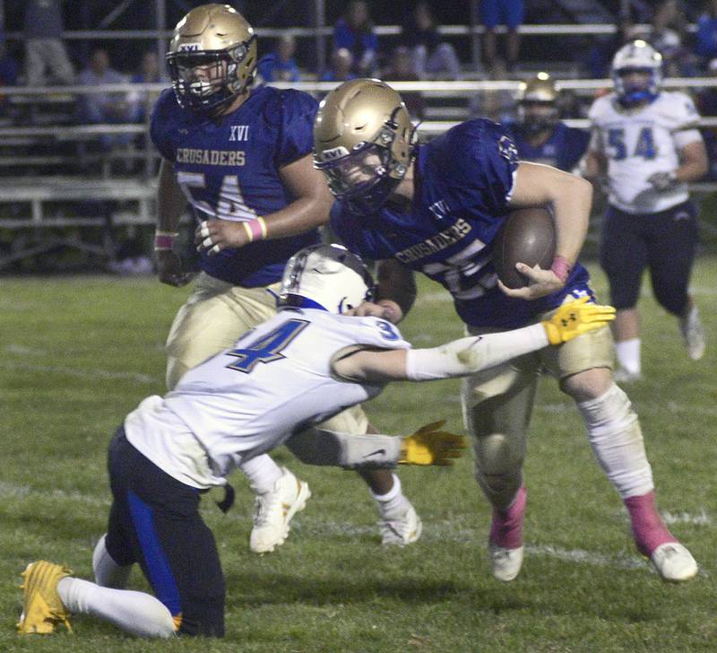 Marquette’s Jansen Higgins works to get past Aurora Central Christian defense on a run in the 1st quarter Friday at Marquette.