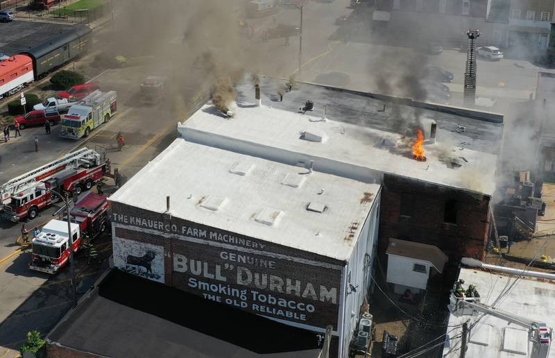 Flames can be scene from the roof of the 800 block building on Main Street in Mendota.