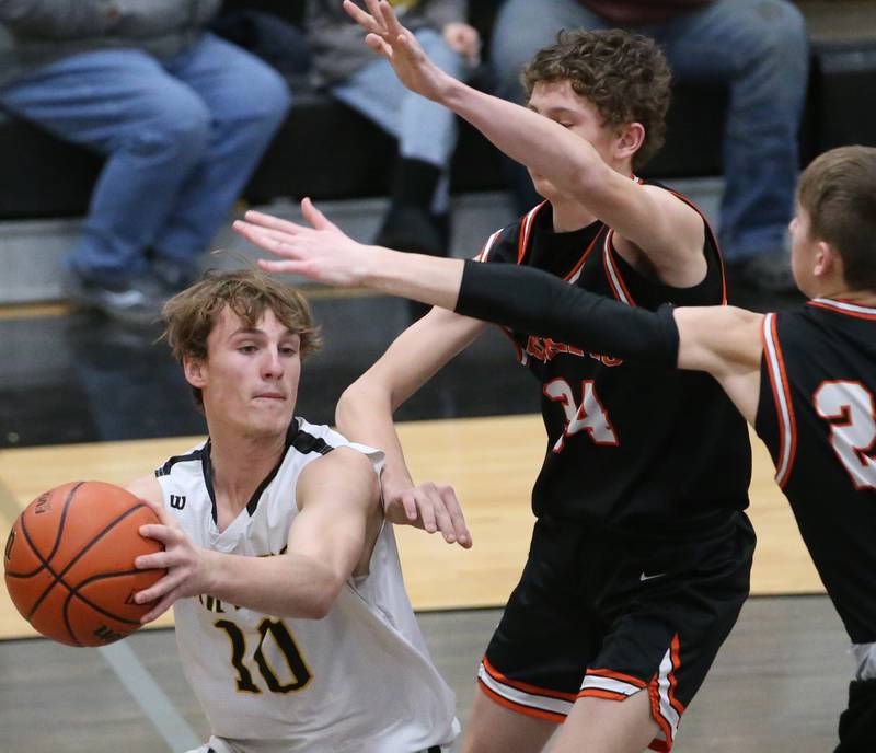 Putnam County's Austin Mattingly keeps the ball away from Roanoke-Benson's Kaden Harms and Jude Zeller during the Tri-County Conference Tournament on Tuesday, Jan. 24, 2023 at Putnam County High School.