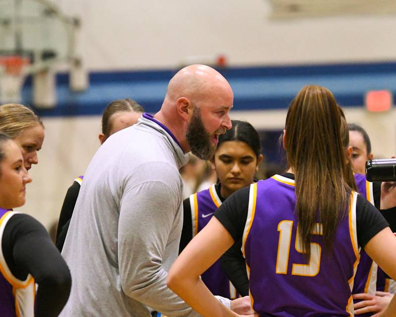 Downers Grove North's head coach Stephen Bolt talks to the team during a timeout during the game on Saturday Dec. 21, 20234, held at Downers Grove South High School.