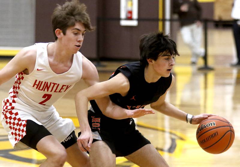 Huntley's John Kramer tries to steal the ball from McHenry’s Marko Visnjevac during a IHSA Class 4A Boys Regional basketball game Wednesday, Feb. 23, 2022, between Huntley and McHenry at Jacobs High School.