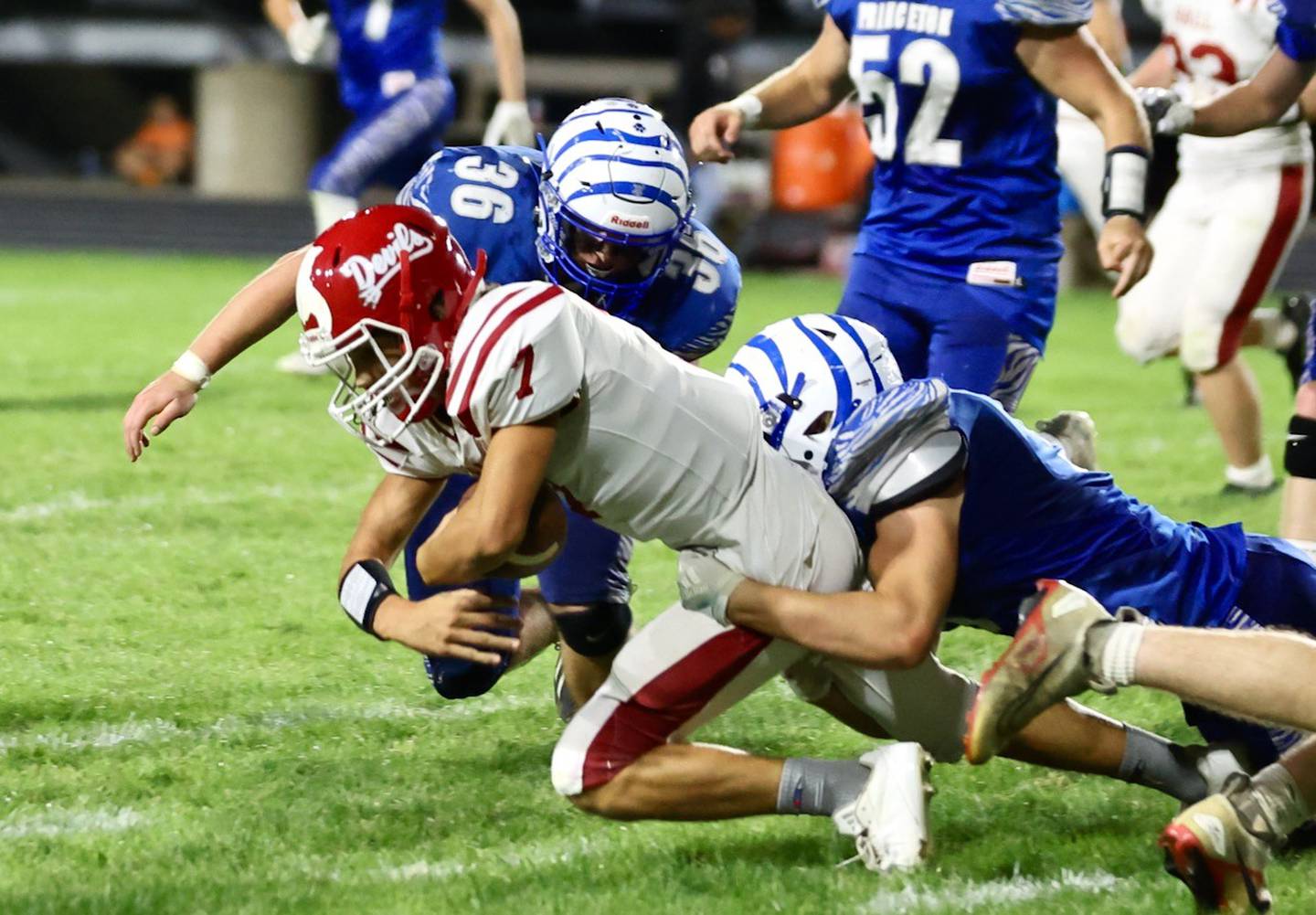 Hall quarterback Dylan Glynn is brought down by Princeton in Friday's game at Bryant Field. The Tigers won 41-0.