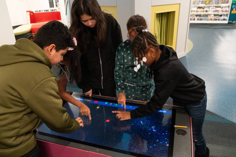 The Joliet Public Library at 150 N. Ottawa St. in Joliet is hosting an all-ages, interactive Exoplanet exhibit from NASA through Feb. 28. Pictured are Joshua Ramirez, Bella Ramirez, Miranda Espina and Rheah Needon.
