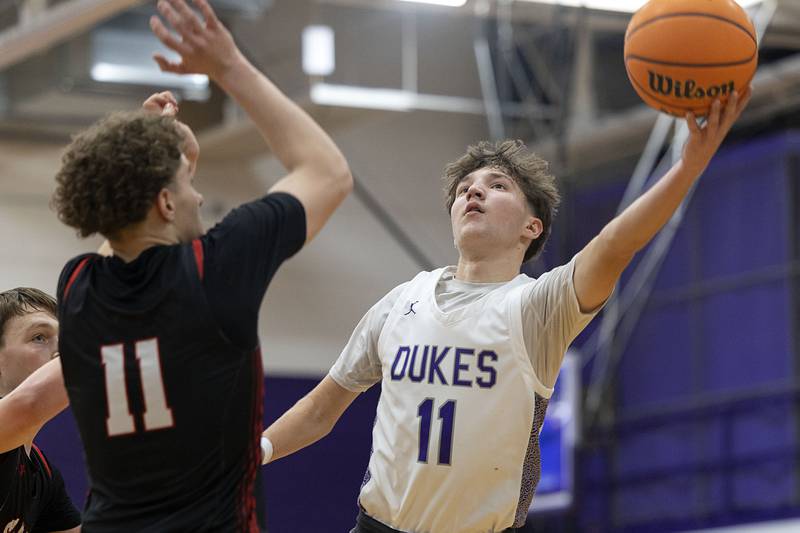 Dixon’s Brody Nicklaus puts up a shot against Stillman Valley’s Evan Eddy Friday, Jan. 9, 2026.