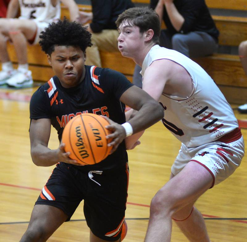 Milledgeville's Micah Toms-Smith (2) drives to the basekt past Forreston's Brendan Greenfield (0) on Wednesday, Dec. 18, 2024 at the 63rd Annual Forreston Holiday Tournament.