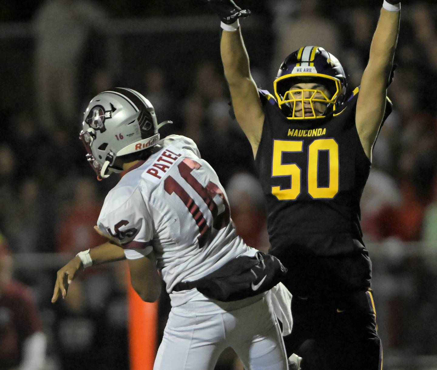 Wauconda’s Eric Alvarado leaps as Antioch’s Ethan Patel passes the ball in a football game in Wauconda on Friday, Oct. 17, 2025.