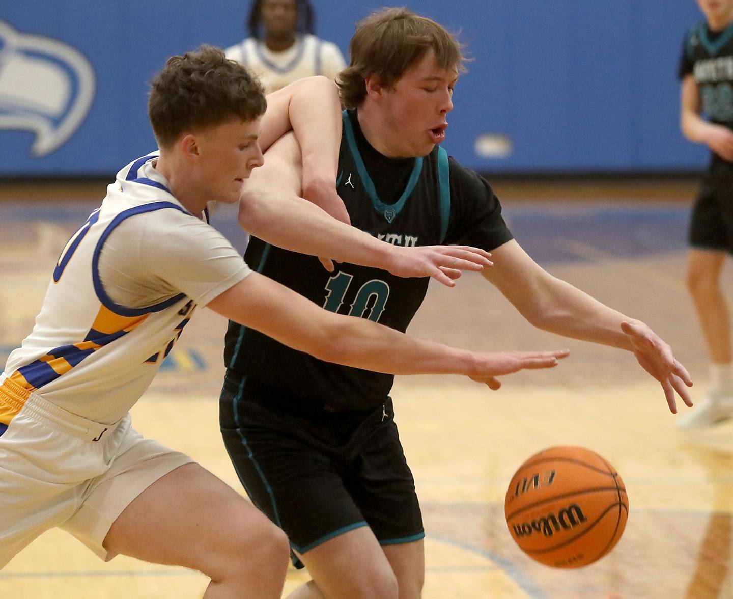 Johnsburg's Josh Kaunas battles with Woodstock North's Brady Rogers for a rebound during a Kishwaukee River Conference boys basketball game on Monday, Dec. 15, 2025, at Johnsburg High School.