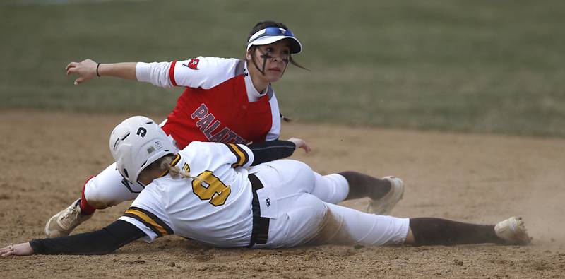 Jacob’s Avarie Lohrmann is tag out sliding into second base by Palatine’s Angie Delgado during a non-conference softball game Monday, March 20, 2023, at Palatine High School.