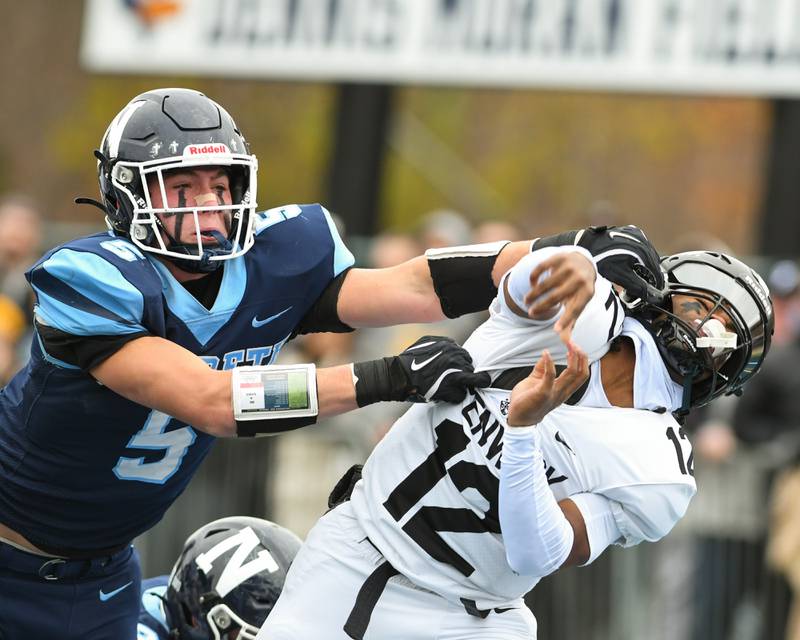 Nazareth Academy's Christopher Kasky, left, tries to block the pass by Fenwick's Jamen Williams (12) during the 6A semifinals game on Saturday Nov. 22, 2025, held at Nazareth Academy High School in La Grange Park.