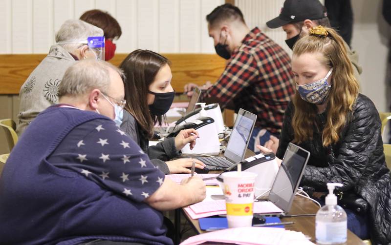 File photo - Volunteers (left) register residents to vote prior to casting their ballots April 6, 2021 at the polling place inside the Westminster Presbyterian Church on Annie Glidden Road in DeKalb.