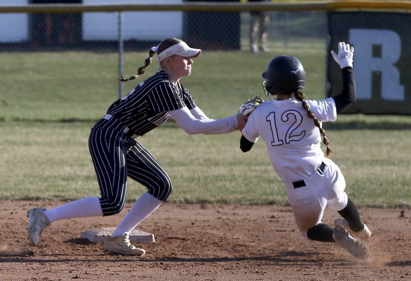 Crystal Lake Central's Kate Show tags out Huntley's Aubrina Adamik as she slides into second base during Fox Valley Conference softball game on Tuesday, April 8, 2025, at Huntley High School.