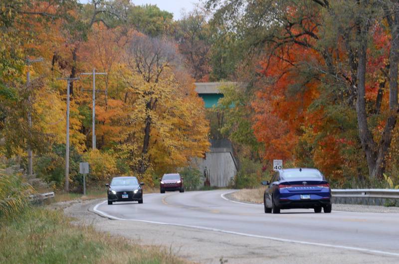 Motorists travel on Illinois Route 71 as fall colors peak on Thursday, Oct. 24, 2024 near Jonesville.
