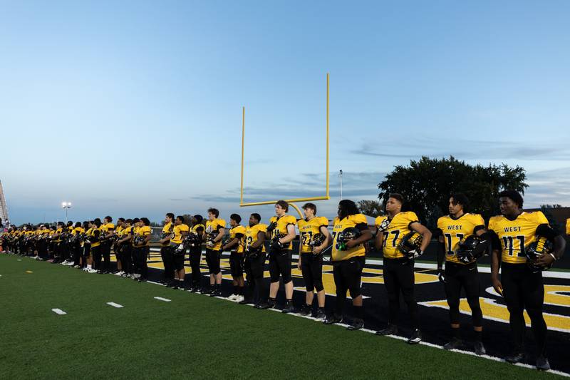 Joliet West’s varsity football team stands during the National Anthem before a varsity football game against Joliet Central at Joliet West on Oct. 24, 2025.