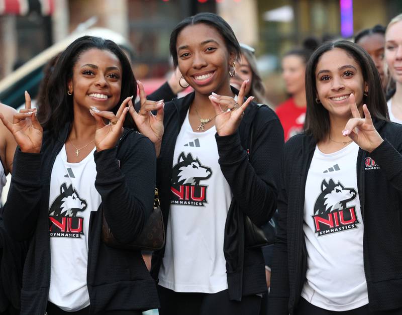 Members of the Northern Illinois University gymnastics team march in the parade Thursday, Oct. 2, 2025, during the Huskie Homecoming Block Party in downtown DeKalb.