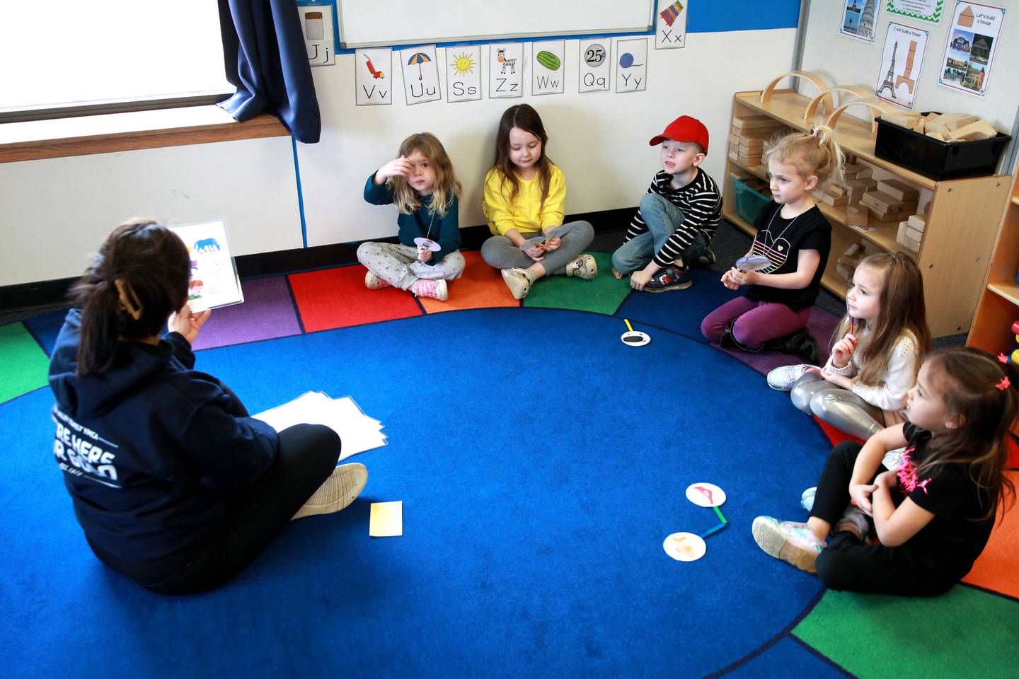 Eva Espino reads a story to some of her students at the Fox Valley YMCA Central Branch’s Early Learning Academy in Plano.
