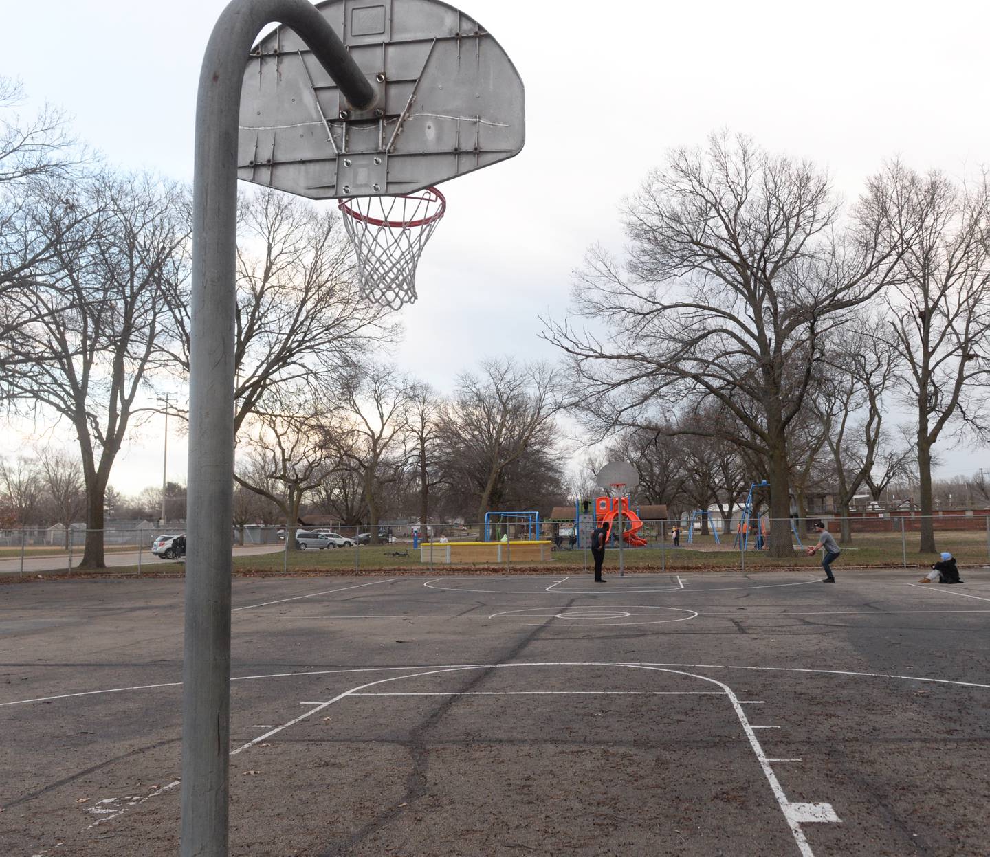 Two men shoot some hoops at the basketball court at Vaile Park in Dixon on Thursday, Feb. 8, 2024. The Dixon Park District has received a state grant to improve the court.